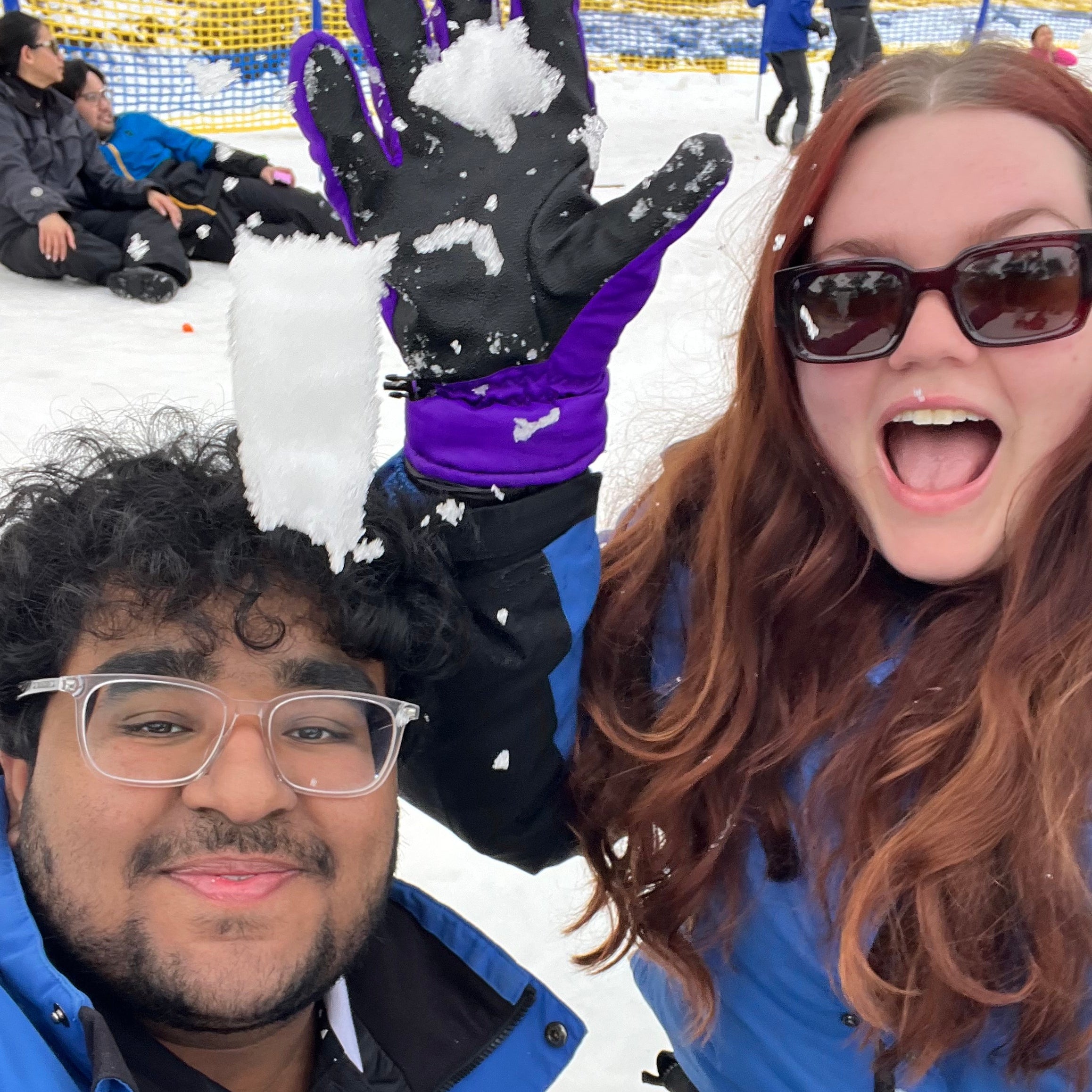The business co owners Abe (Left) & Ellen (Right). Two people taking a selfie in the snow, wearing winter clothing and sunglasses.
